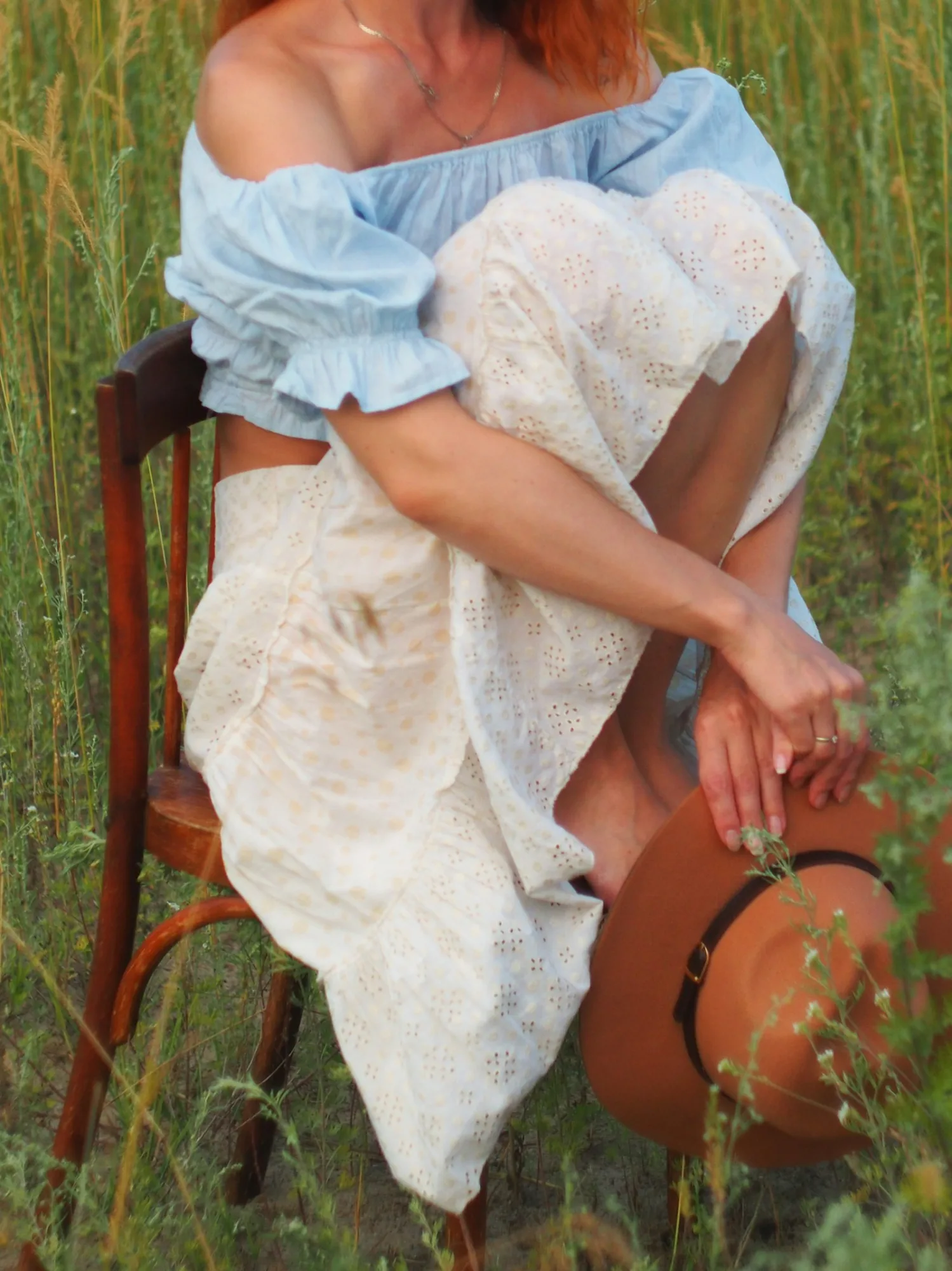 Tiered eyelet prairie skirt with an off-shoulder top and felt hat