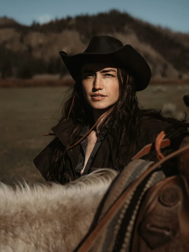 Black felt cowgirl hat worn horseback in the foothills
