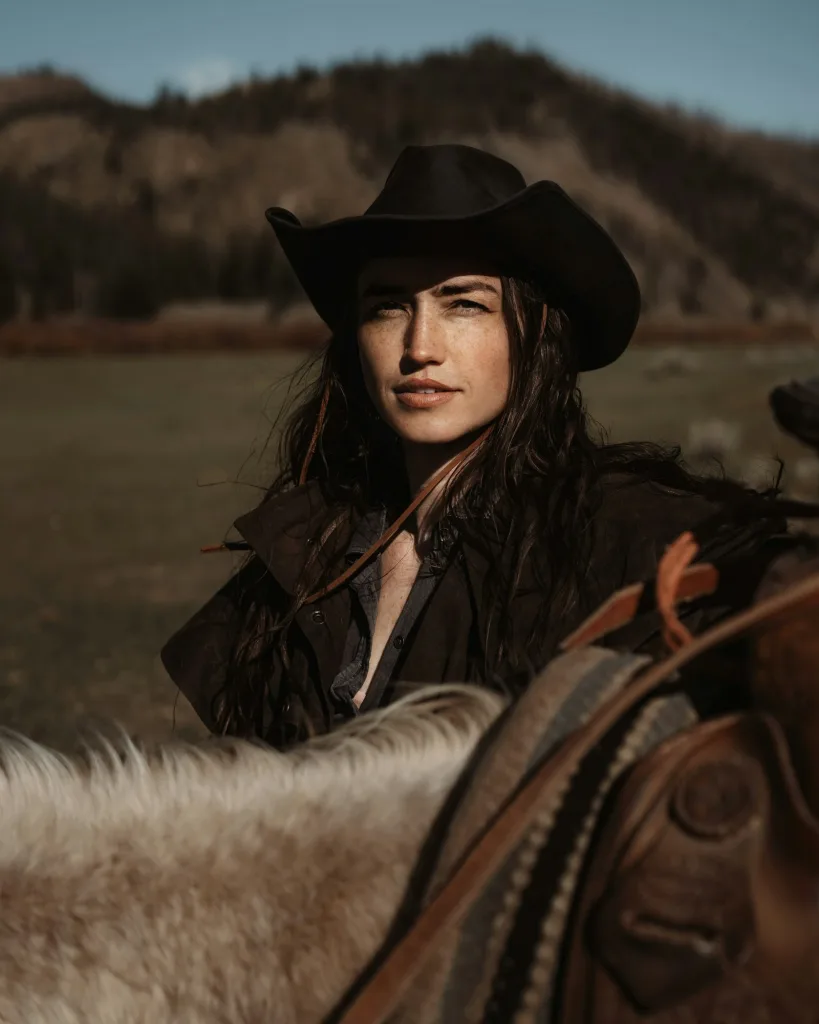 Black felt cowgirl hat worn horseback in the foothills