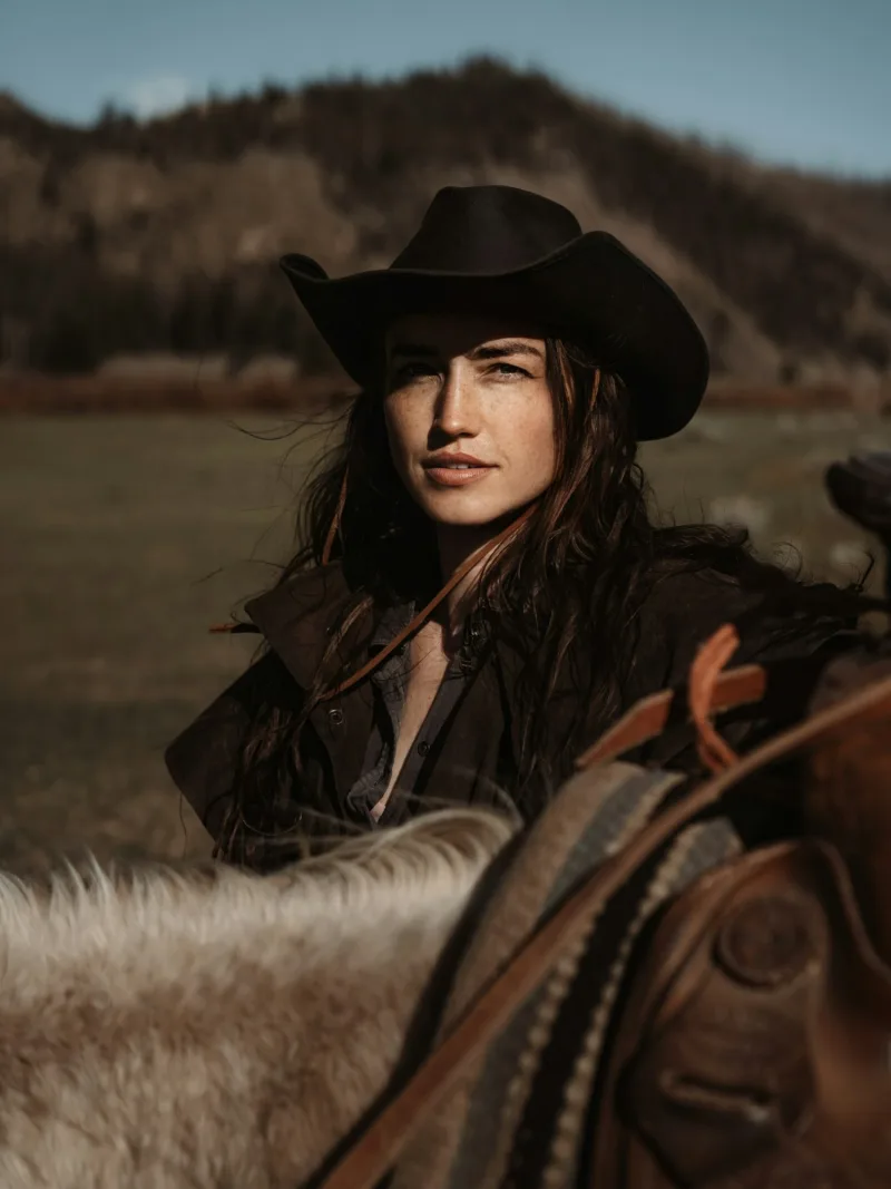 Black felt cowgirl hat three-quarter view on horseback