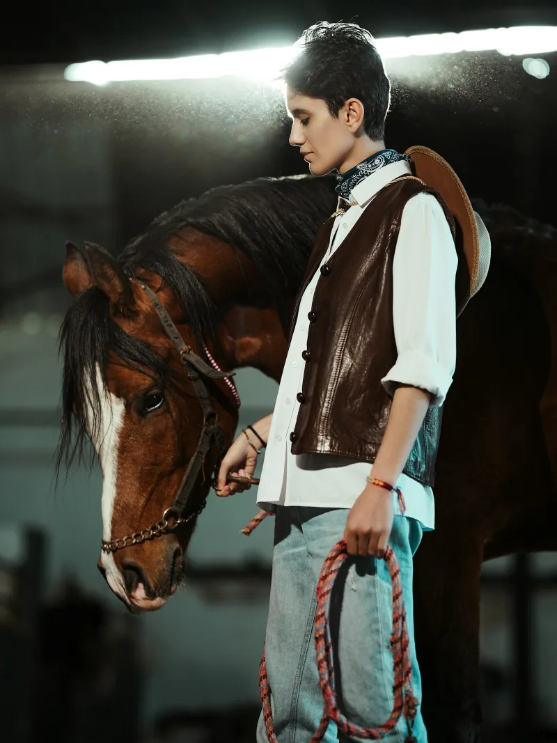Brown suede western vest over a white shirt, stable light