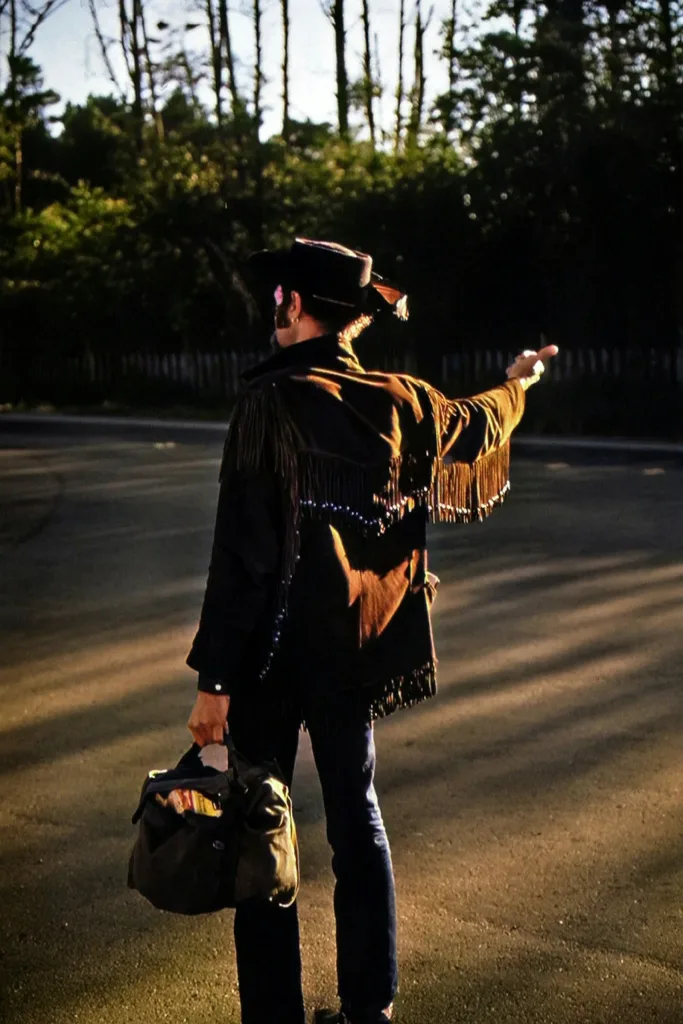 Black fringe jacket under night road lights
