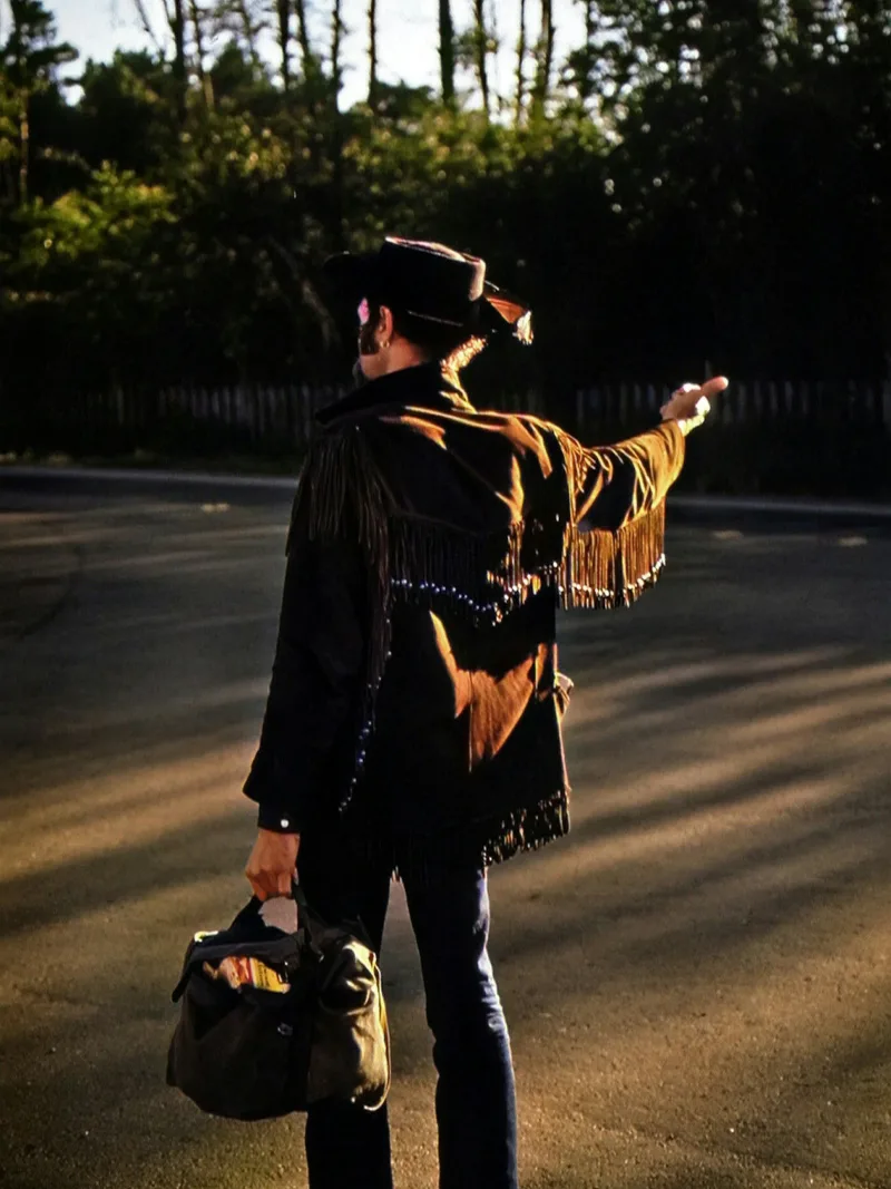 Black fringe jacket under night road lights